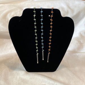 Set of three vintage Avon beaded ankle bracelets, one green, one aqua one coral.